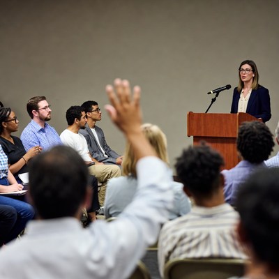 Woman speaking at diverse group seminar