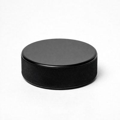 Black hockey puck isolated