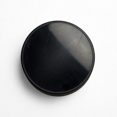 Black hockey puck isolated