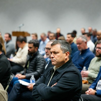 Men sitting in conference audience