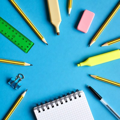 School Supplies Arranged on Blue Background