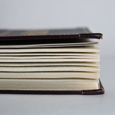 Open Leather Book on White Background