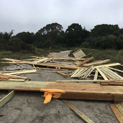 Scattered Wooden Boards on Sandy Path