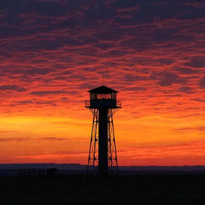 Watchtower silhouetted against sunset