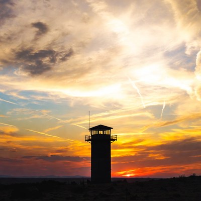 Lighthouse silhouette at sunset