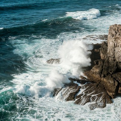 Ocean Waves Crashing Against Cliff
