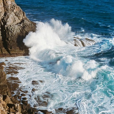 Ocean Waves Crashing on Rocky Cliff
