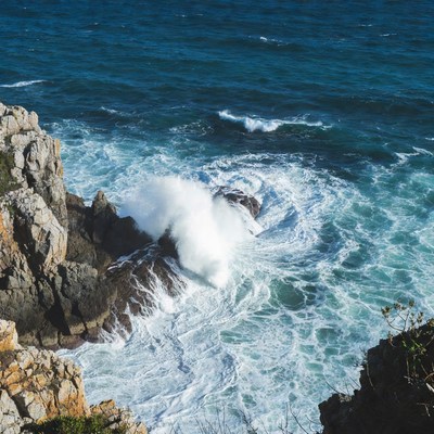 Ocean Waves Crashing on Rocky Cliff