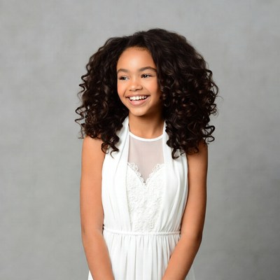 Smiling Black girl in white lace dress
