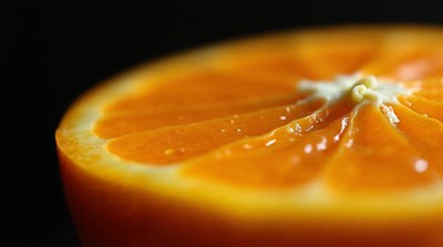 Close-up sliced orange on black