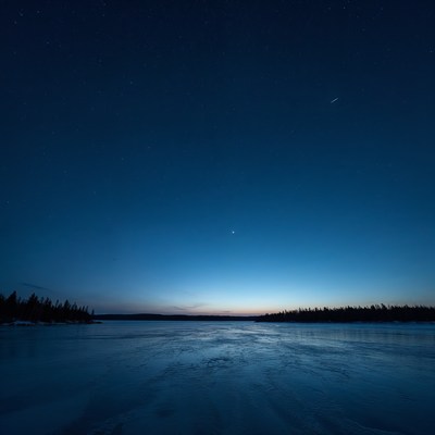 Frozen lake under starry night sky