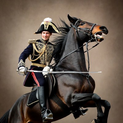 Man in military uniform riding rearing horse