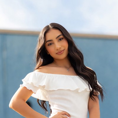 Latina woman in white off-shoulder top