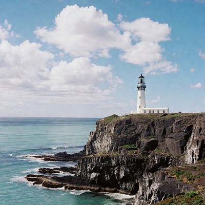 White lighthouse on ocean cliff