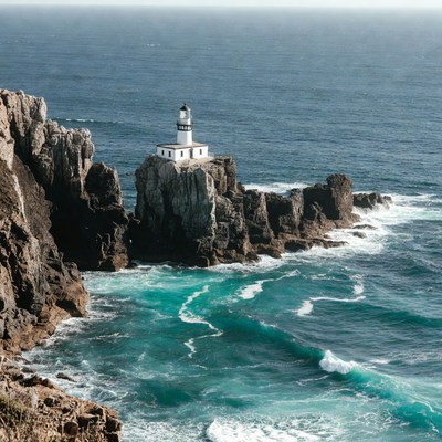 Lighthouse on rocky ocean cliff