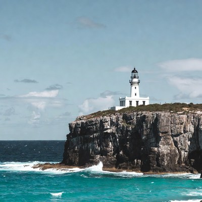 White Lighthouse on Cliff Over Ocean