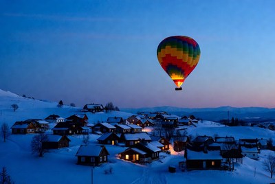 Hot Air Balloon Over Snowy Mountain Village