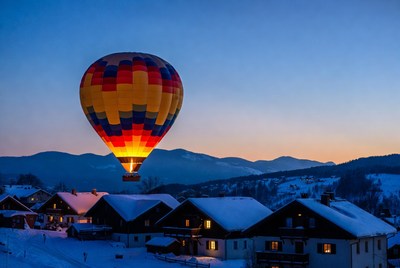 Hot Air Balloon Over Snowy Alpine Village