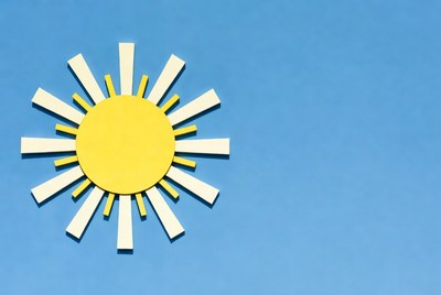 Yellow Paper Sun on Blue Background