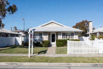 White house for sale with sign