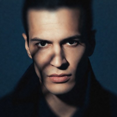 Intense close-up of man in dark coat