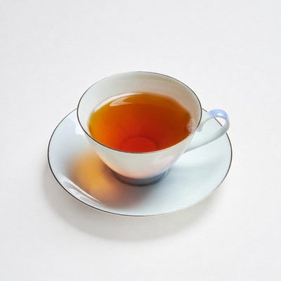 Teacup with tea on saucer