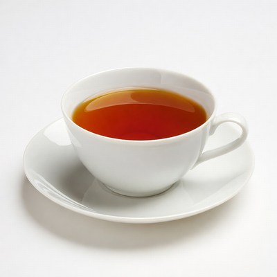 White teacup with tea on saucer