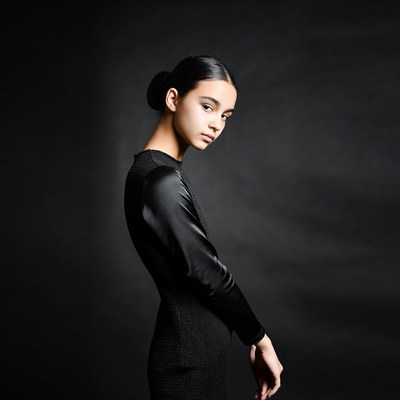 Side profile of young woman in black dress