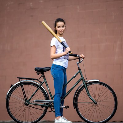 Girl with baseball bat and bicycle