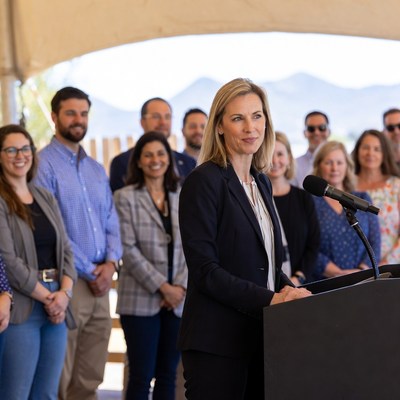 Blonde woman speaking at podium