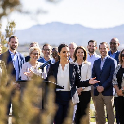 Woman speaking at podium with diverse group