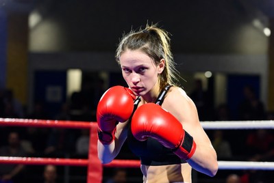 Female boxer in red gloves