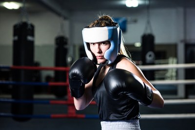 Woman boxer in headgear and gloves