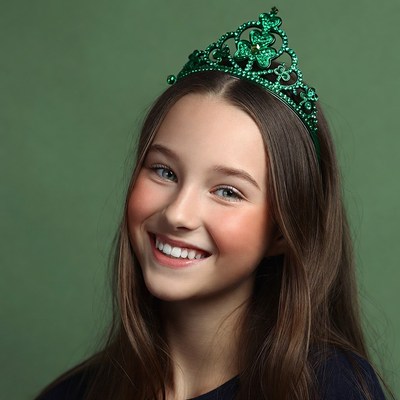 Girl smiling with green shamrock crown
