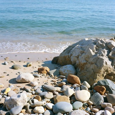 Pebbles and rocks on beach by ocean