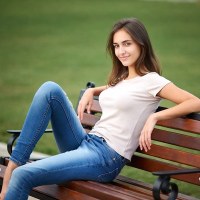 Young woman sitting on park bench