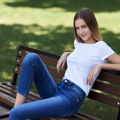 Young woman sitting on park bench