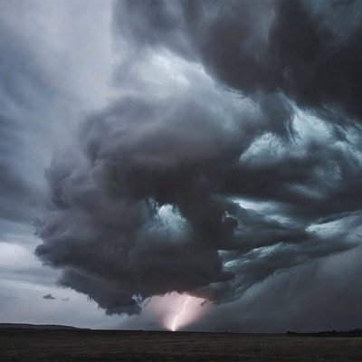 Lightning striking under dramatic storm clouds