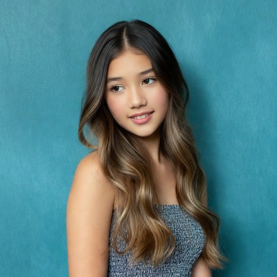 Asian girl smiling on blue background