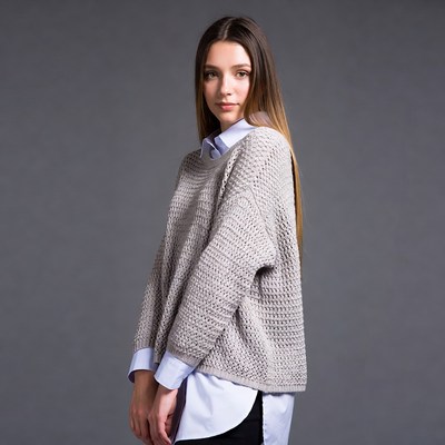 Woman in gray oversized sweater