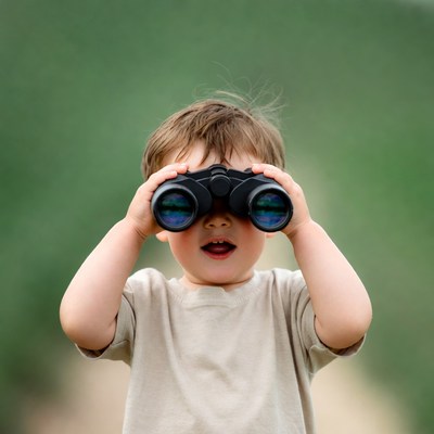 Boy looking through binoculars