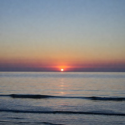 Sunset over ocean waves