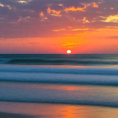 Sunset over ocean waves