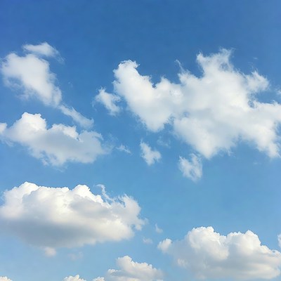Fluffy white clouds in blue sky