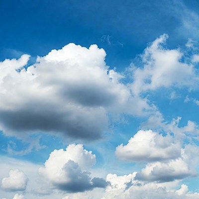 Fluffy white clouds in blue sky