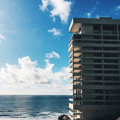 Tall Building Overlooking Ocean Cliff