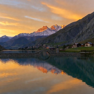 Stone Bridge over Lake at Sunset Mountains