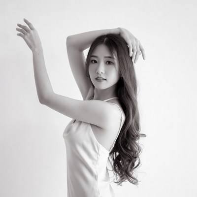 Asian woman posing with arms raised