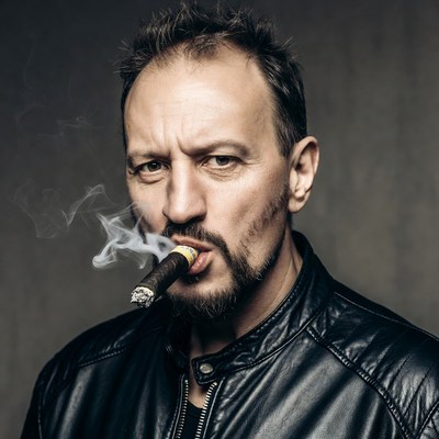 Man smoking cigar in leather jacket