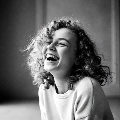 Woman laughing with curly hair